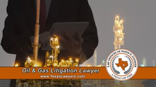 Attorney reviewing a tablet in front of an illuminated Texas oil and gas refinery