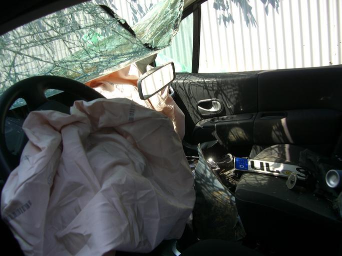 This image is a picture of an autombile with a deployed airbag after a crash that symbolizes the importance of working airbags.