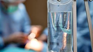 Surgeon implanting a port catheter into a patient.