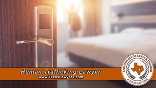 A person sits alone in a dim hotel hallway, symbolizing the isolation and fear that human trafficking survivors in Texas often experience before reaching out for help.