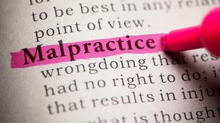 The word Malpractice highlighted in pink on a printed dictionary page, with the tip of a pink highlighter visible beside it that symbolizes a professional malpractice lawsuit.