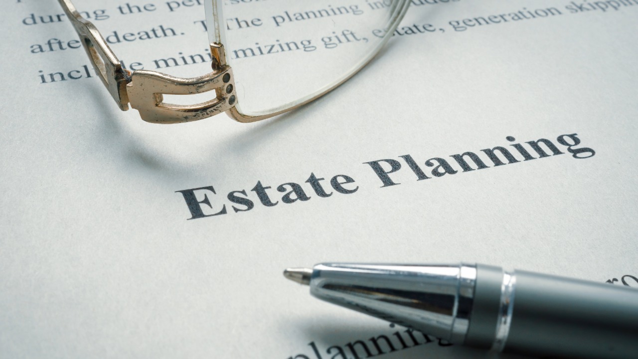 Reading glasses and a pen resting on a document titled Estate Planning, representing Texas estate planning legal services.